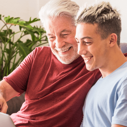 A man with his son smiling after receiving dentures.