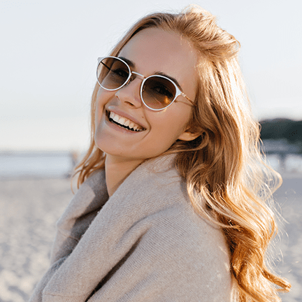 A woman showing her bright smile after having a white filling.